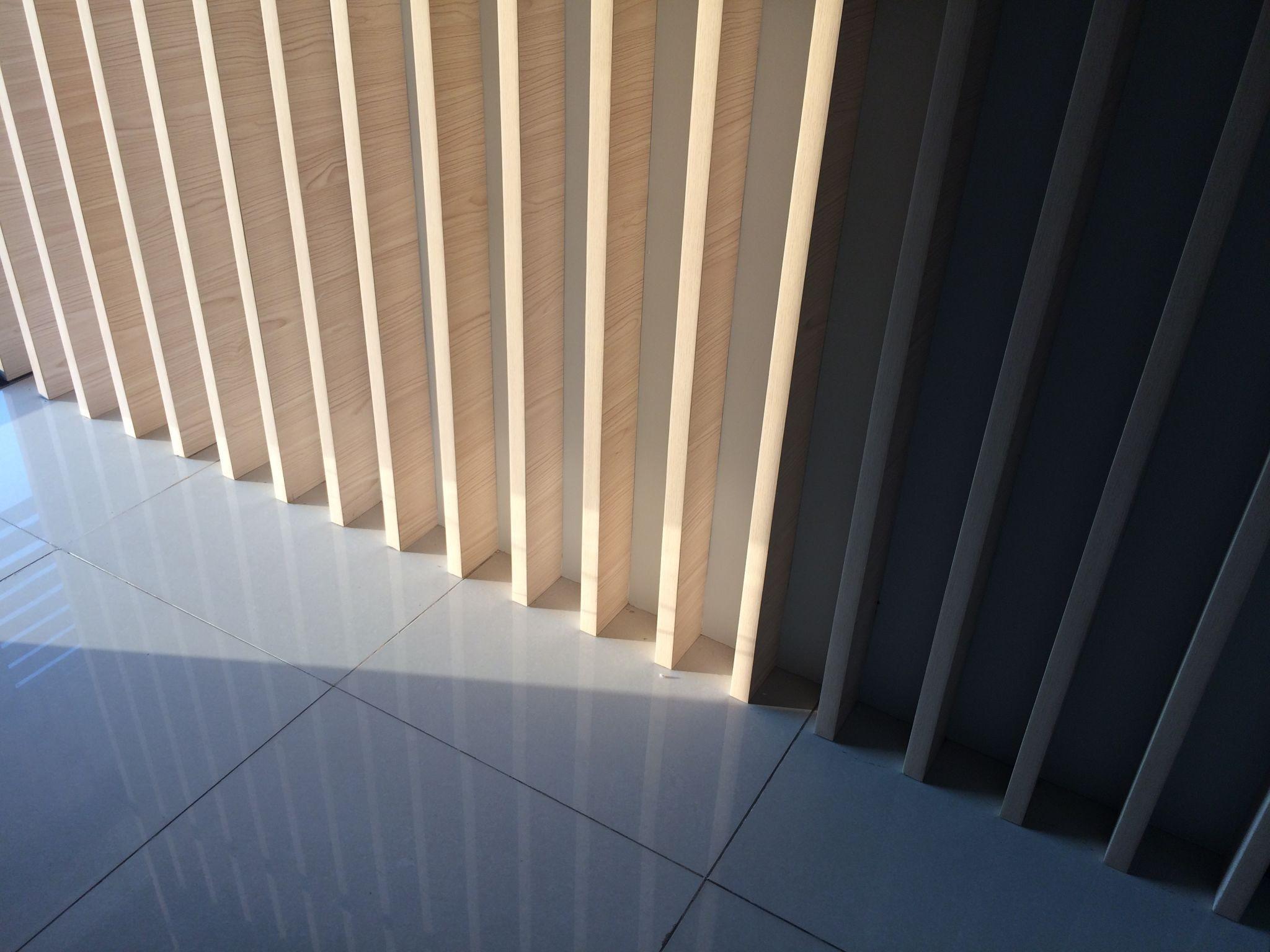 Minimal luxury interior with warm natural lighting, clean architectural lines, soft textures, and human presence.